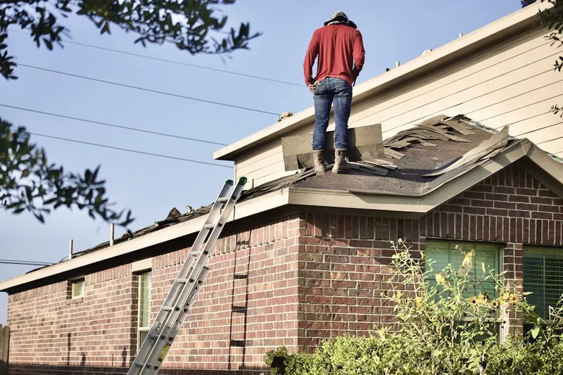 Professional roofer working on a residential roof in Kimberly Woods Village